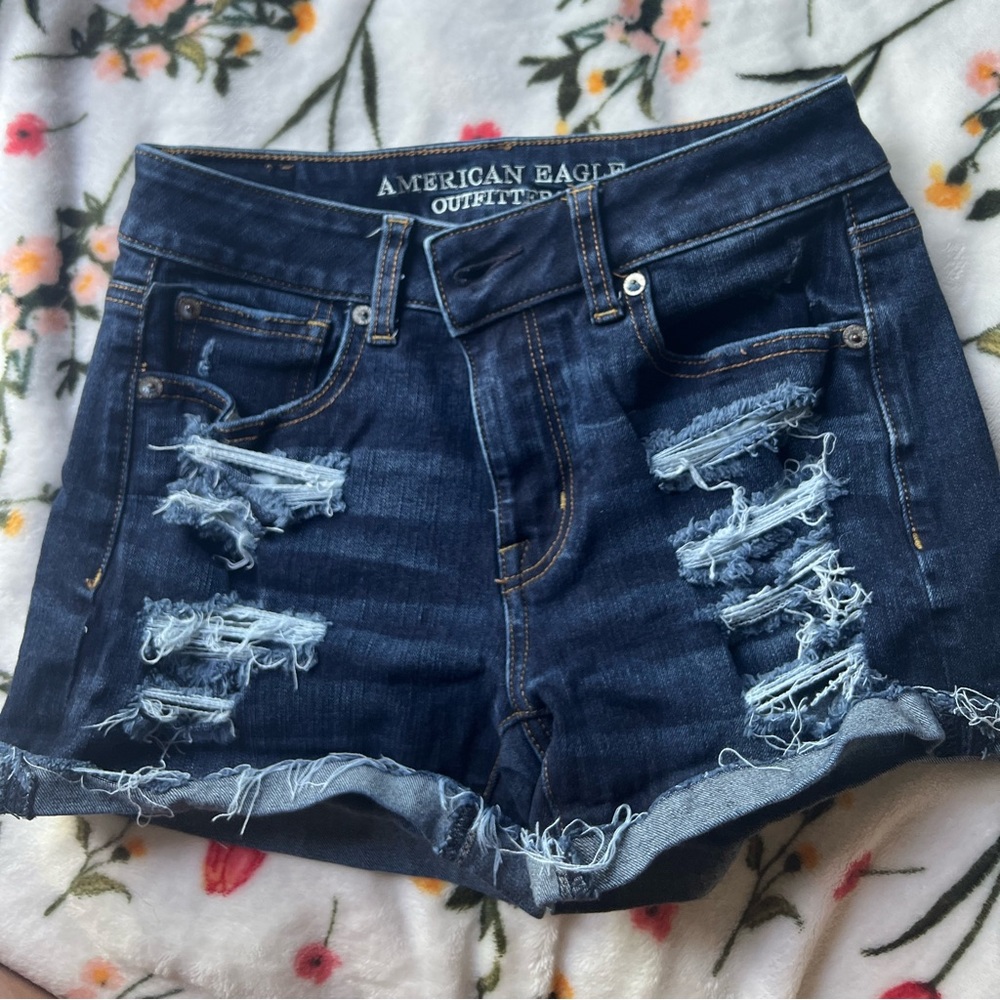 American Eagle jean dark washed shorts with rips.